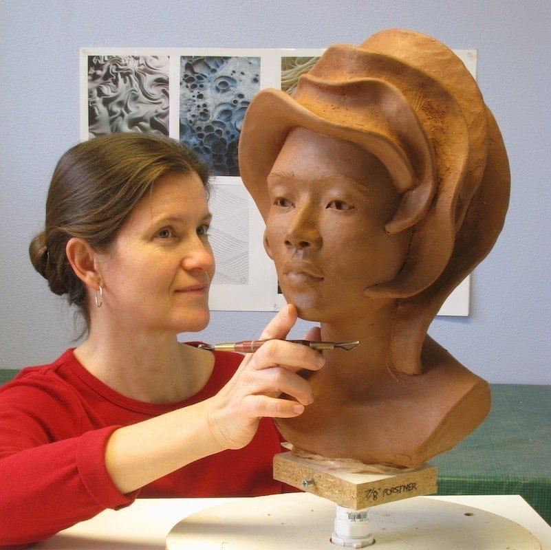 Christine L. Evans working in the studio on the "Luna" bust sculpture.